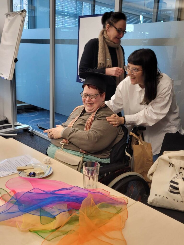 Sandra Seiser lacht in die Kamera, sie hat einen Doktorhut auf.